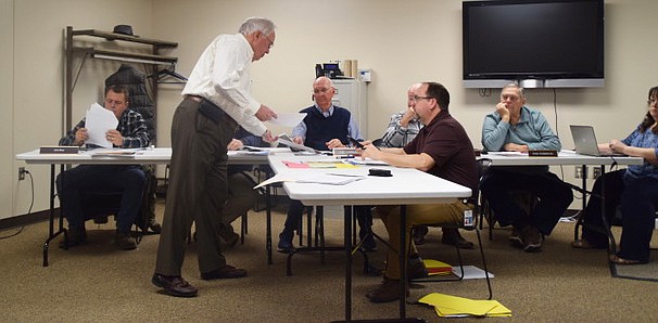 Attorney Steve Snyder (middle) gives a handout to Lee Harman. Seated in front of Snyder is Matt Sandy, Area Plan director. In the back (L to R) are John Beer, Kevin McSherry (hidden by Snyder), Harman, Randy Cox and Ron Robinson. Photo by Lauren Zeugner, InkFreeNews