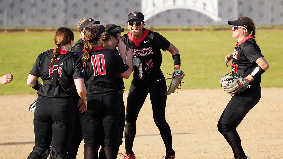 Pictured is the Grace softball team celebrating its 8-0 win over Marion.