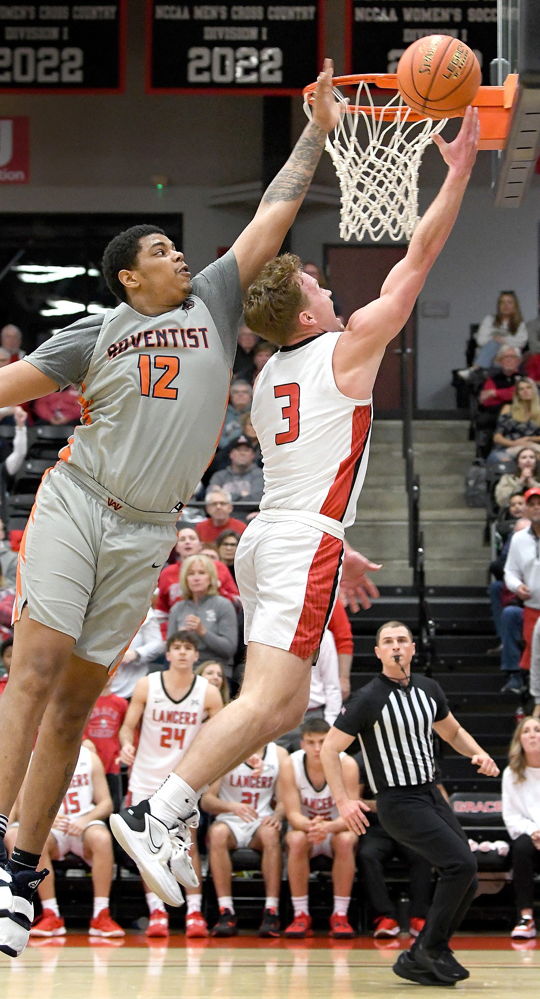 Junior Brett Sickafoose of Grace reaches out for a shot ahead of Washington Adventist's Isaiah Anderson. Photo by Gary Nieter