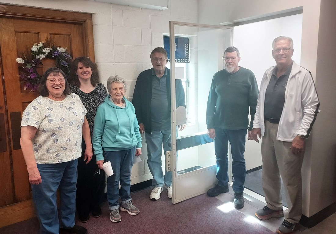 (L to R) Trinity United Methodist Church trustee Jean Teune, Pastor Andrea Texeira and trustees Verna Carlin, Dave Kintzel, Tim Gaisford and Glen Yoder stand by the church’s newly installed lift. Not pictured is church trustee Elliot Enders. Photo by Jackie Gorski, Times-Union