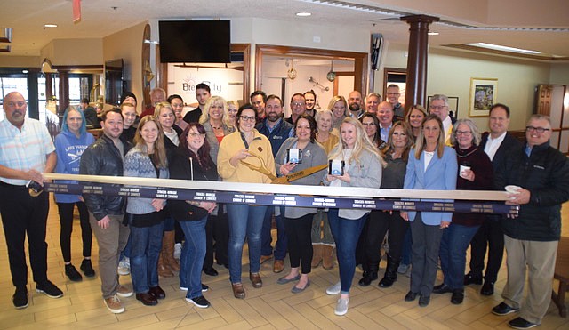 Brew City Coffee held a ribbon-cutting Monday celebrating the opening of its second location in Syracuse, in the lobby of the Oakwood Inn. Shown are employees of Brew City along with members of the Syracuse-Wawasee Chamber of Commerce and Kosciusko County Chamber of Commerce. Photo by Lauren Zeugner, InkFreeNews