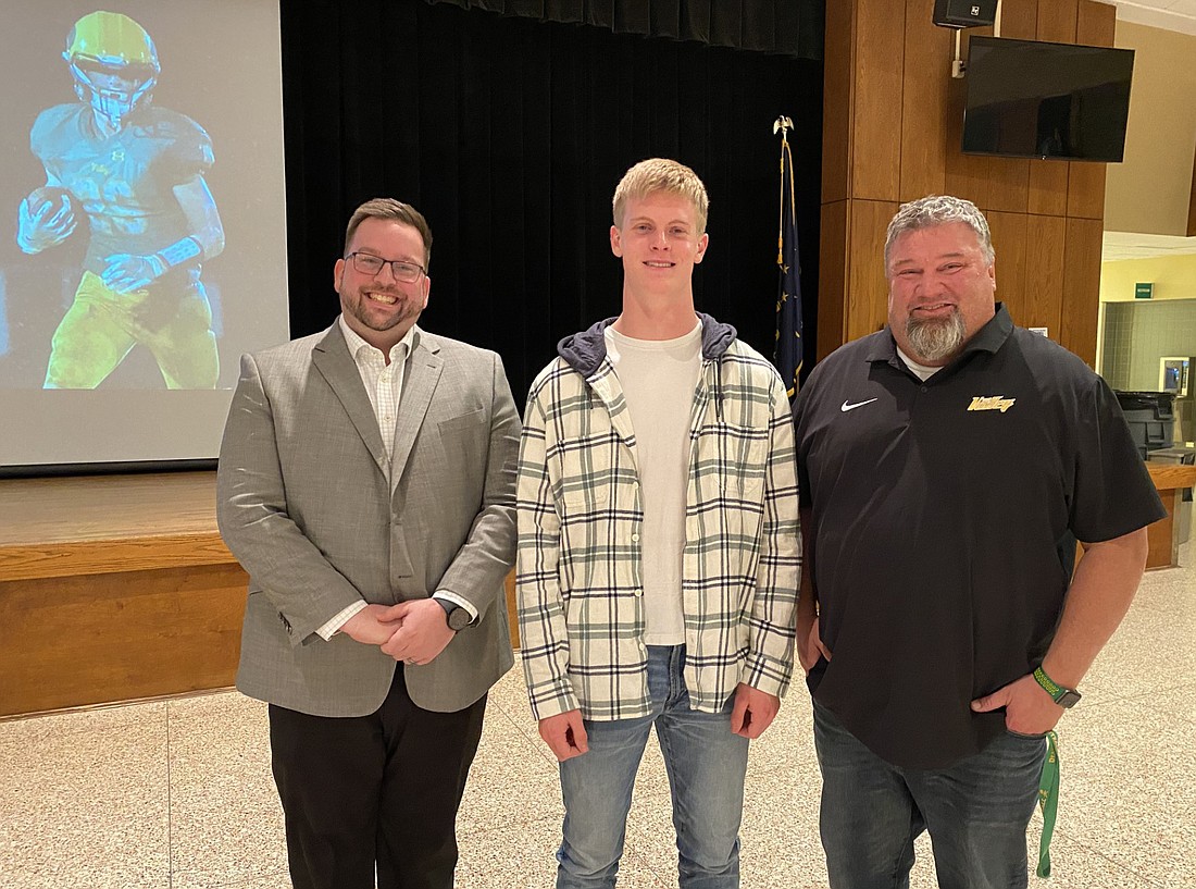 Tippecanoe Valley High School’s Wade Jones (C) will play in the Indiana Football Coaches' Association North-South Football All Star Classic on July 12 at Decatur Central High School in Indianapolis. He was recognized at the Tippecanoe Valley School Board meeting on Monday at TVHS. With him are TVHS Principal Brandon Kresca (L) and head football coach Steve Moriarty (R). Photo by Leah Sander, InkFreeNews