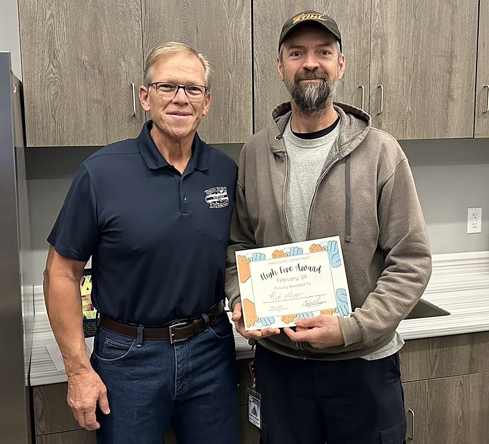 Warsaw Parks and Recreation Department Superintendent Larry Plummer (L) stands with department employee Rob Moyer, who won the department’s “High Five Award” in February. Photo Provided.