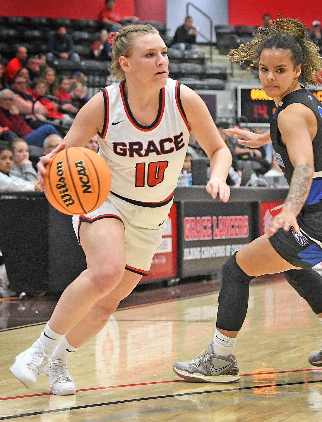 Junior Kensie Ryman of Grace dribbles around a defender during Wednesday night's opening round NCCAA game. Photo by Gary Nieter