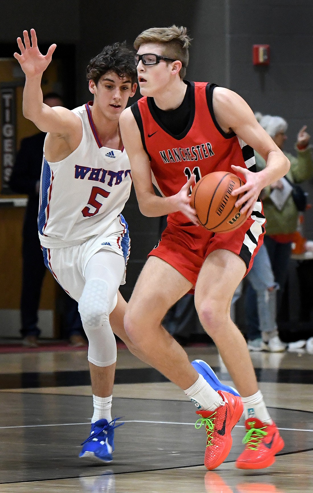 Manchester junior and 2024 Times-Union Boys Basketball Player of the Year Gavin Betten survey’s the court as Whitko’s Sam Essegian defends.