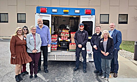 Lynn Mergen, CEO of Lutheran Kosciusko Hospital, and team present the donation of peanut butter to Randy Polston, executive director of Combined Community Services. Photo Provided.