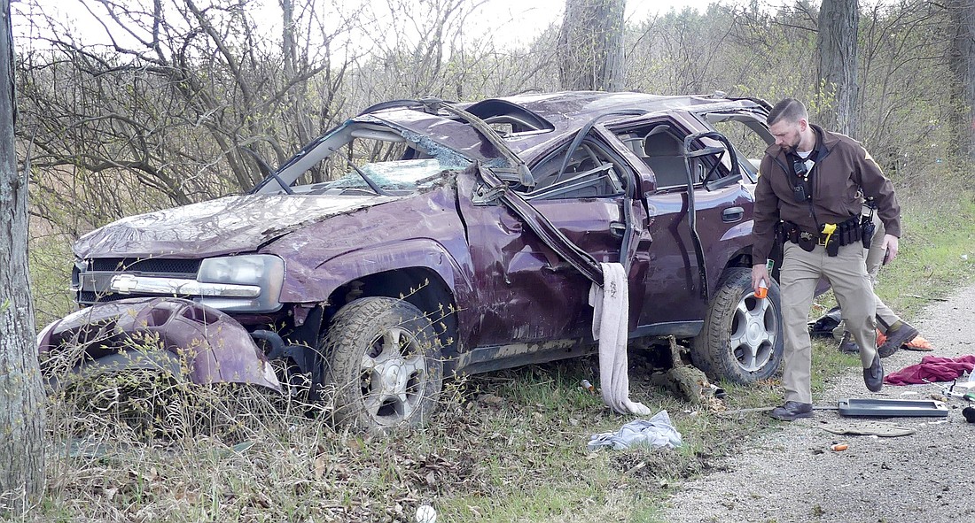 Kosciusko County Sheriff’s Office Sgt. Justin Smith investigates the scene of Friday evening's single-vehicle accident on CR 1000N at CR 450E. Photo by Gary Nieter, Times-Union