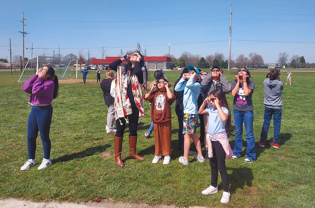 Leesburg Elementary Dual Language Immersion teacher Clara Borda (second from left) views the solar eclipse Monday with students at the school. Photo by Jackie Gorski, Times-Union