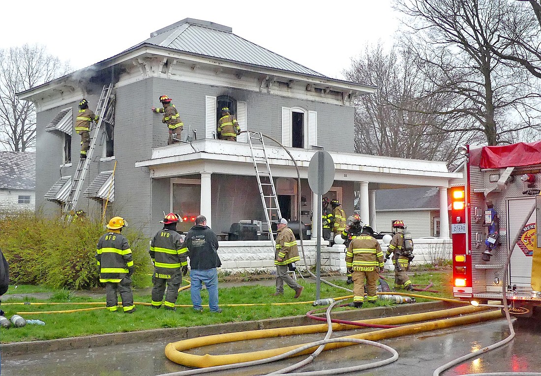 Mentone and Burket firefighters quickly work to battle Sunday evening's house fire on North Franklin Street in Mentone. Photo by Gary Nieter, Times-Union
