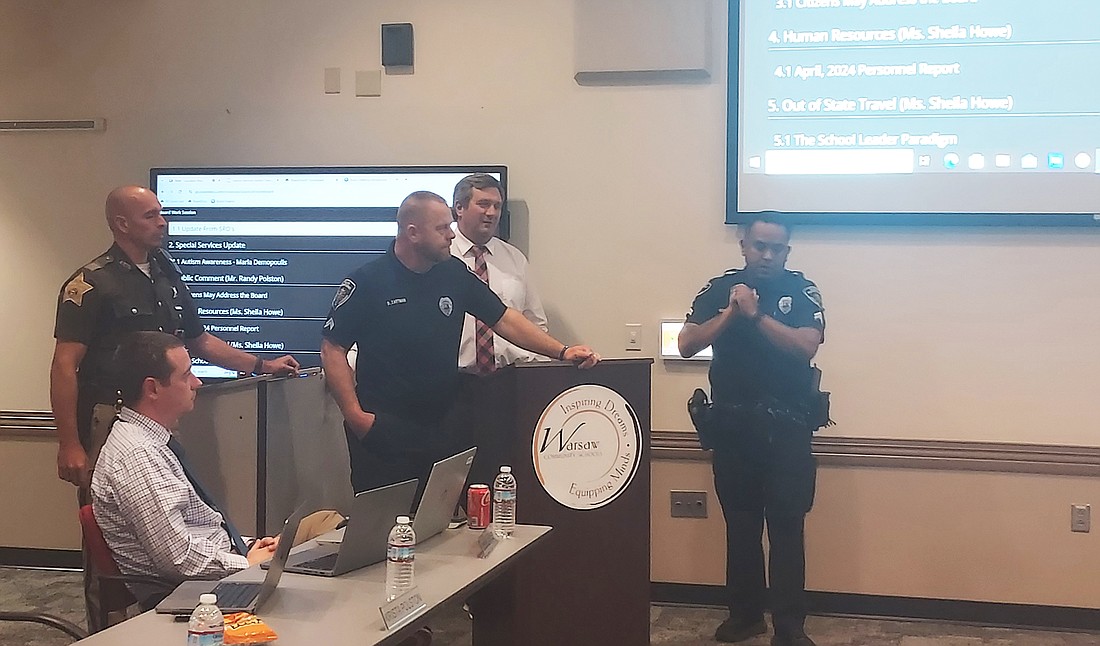 (L to R) School resource officers Joel Popenfoose, Brandon Zartman and Roy Navarro talk to the Warsaw School Board Tuesday. Photo by Jackie Gorski, Times-Union