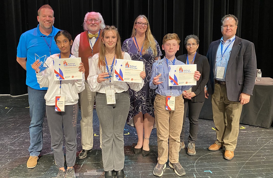 Kosciusko Chamber of Commerce hosted a civics bee for sixth- through eighth-grade students on Tuesday at the Warsaw Community High School Performing Arts Center. Shown are winner Arthur Satter, second-place finisher Fiona Steuer and third-place finisher Medha Aluru with judges for the competition. Pictured (L to R) are, front row: Aluru, Steuer and Satter; back row: judges Chad Hummel, Dr. Mark Norris, Tiffany Fields, Marlene Betances and Doug Hanes. Photo by Leah Sander, InkFreeNews