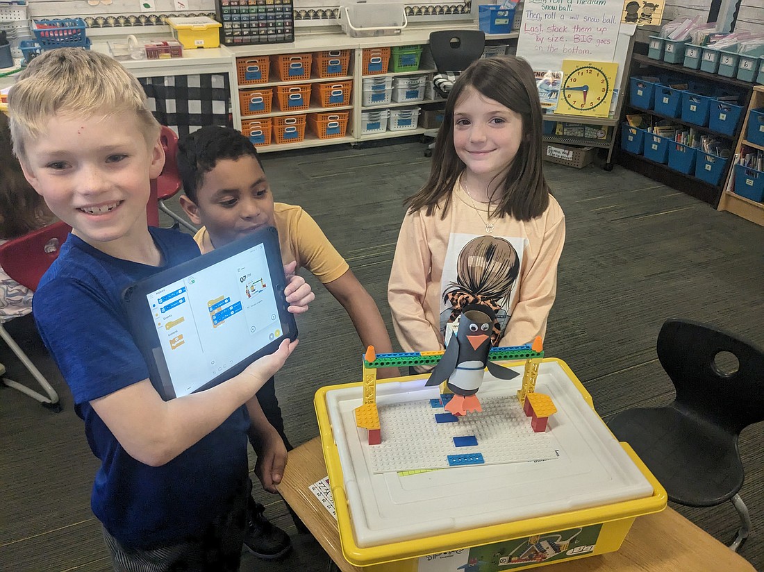 Pictured are first-graders coding their Penguin Robots. Photo Provided.