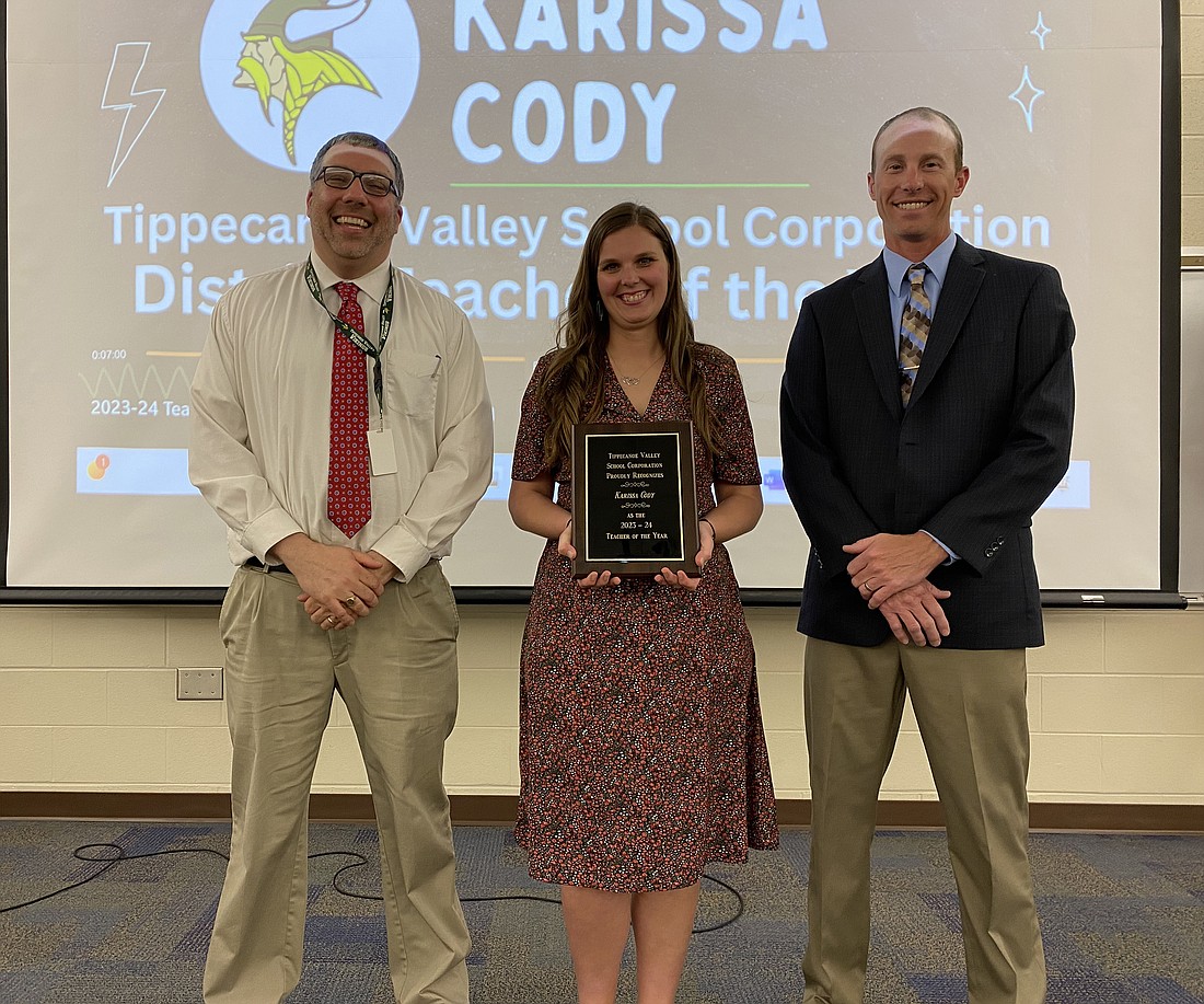 Mentone Elementary School instructional coach Karissa Cody (C) was recognized as Tippecanoe Valley School Corporation’s Teacher of the Year at the TVSC Board meeting Monday at Mentone Elementary. With her are Mentone Principal Randy Dahms (L) and Board President Adam Heckaman (R). Photo by Leah Sander, InkFreeNews