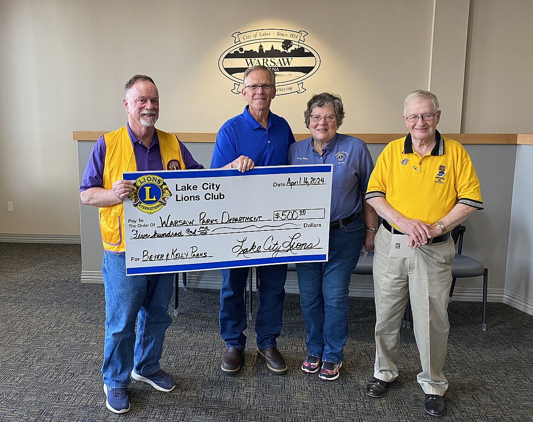 The Lake City Lions Club of Warsaw gave the Warsaw Parks and Recreation Department $500 on Tuesday as a thank you for parks’ employees repairing buildings the club had donated to the department years ago. Pictured (L to R) are Club Secretary Jon Garber, Warsaw Parks and Recreation Department Superintendent Larry Plummer, Club Treasurer Sheri Reeve and Club President Duane Griner. Photo by Leah Sander, InkFreeNews