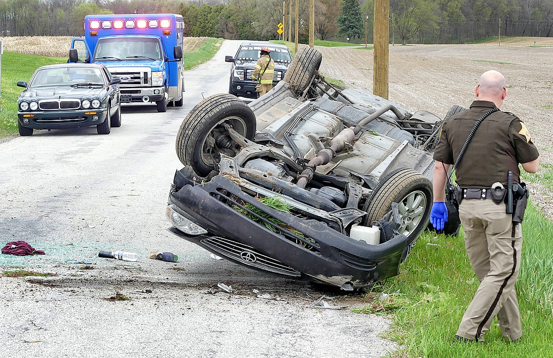 Kosciusko County Sheriff’s Office deputy Adam Behnke investigates Wednesday afternoon's single-vehicle roll-over accident on Union Street, west of Ind. 15. Photo by Gary Nieter, Times-Union