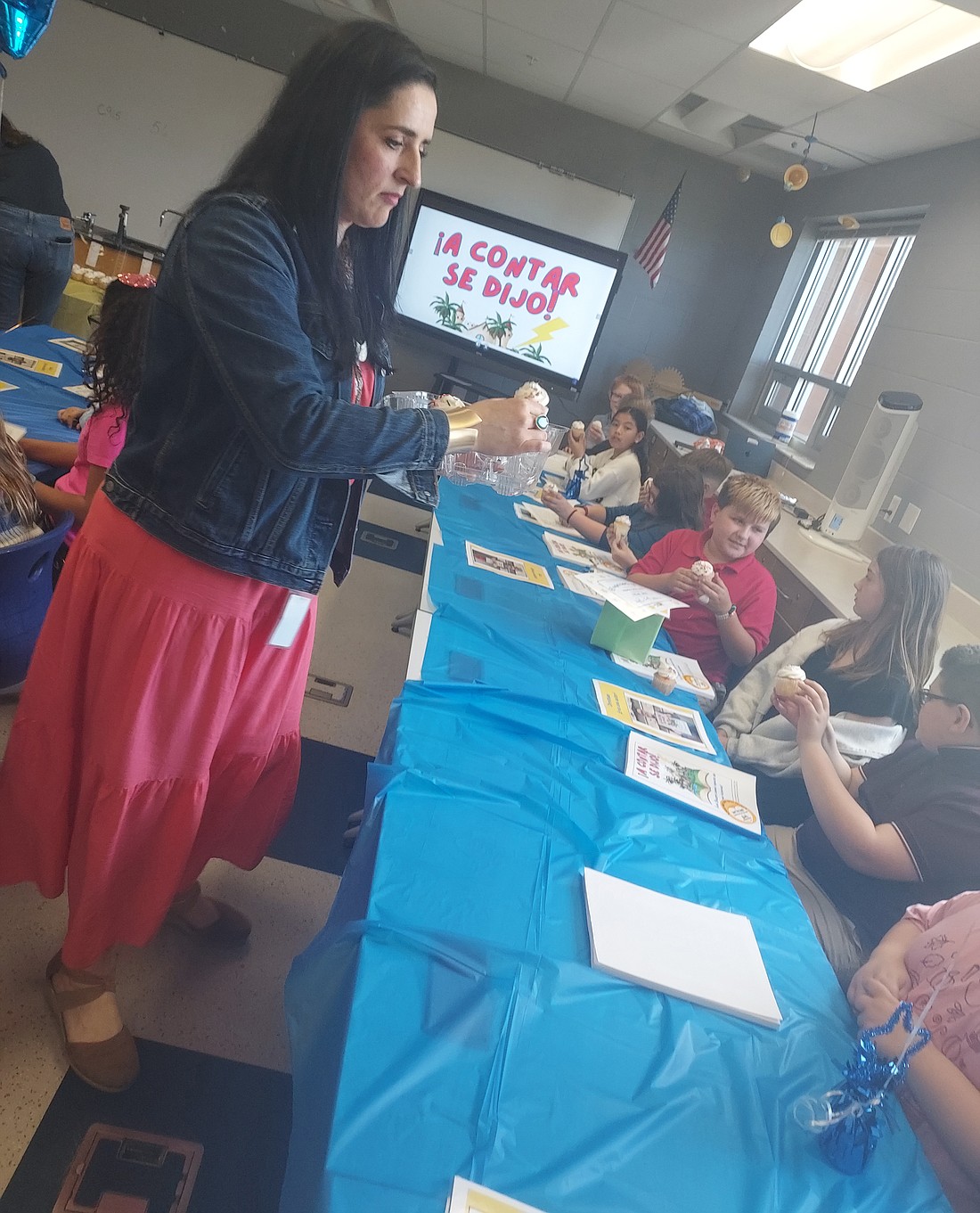 Clara Borda, dual language immersion teacher at Leesburg Elementary School, passes out cupcakes to students Friday. Photo by Jackie Gorski, Times-Union