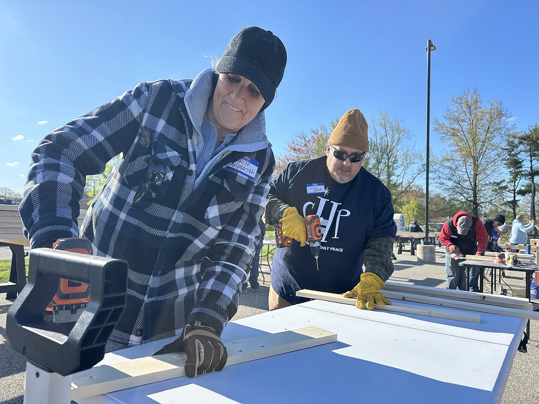 Superior Court I Judge Karin McGrath (L) and attorney Antony Garza (R) drills holes in boards during the Sleep in Heavenly Peace bed build Saturday morning at the Bowen Center in Warsaw. Photo by David Slone, Times-Union