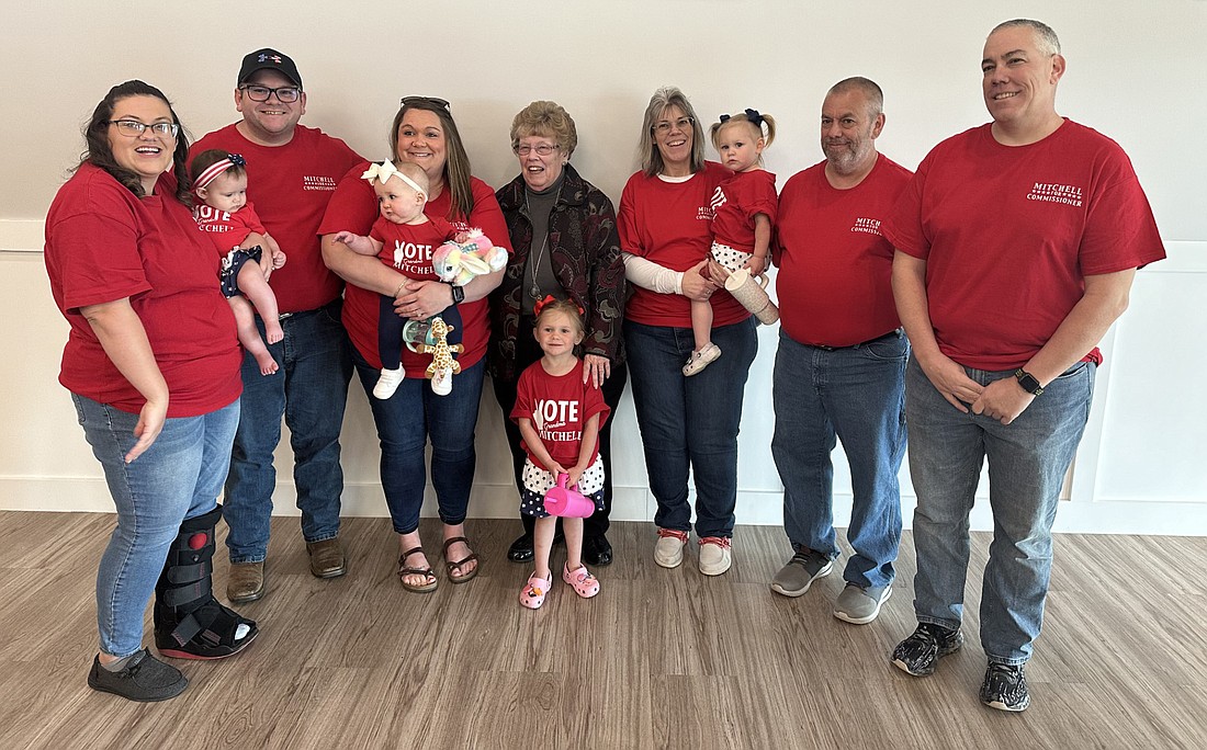 Kosciusko County northern district county commissioner candidate Sue Ann Mitchell (C) poses for a group photo with her family Monday night at a reception at the Zimmer Biomet Center Lake Pavilion. Photo by David Slone, Times-Union