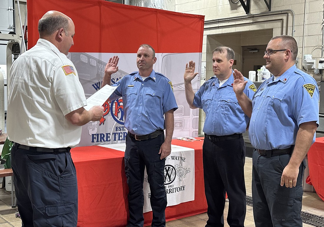 Warsaw-Wayne Fire Territory Assistant Chief Aaron Bolinger (L) gives the oath to Capt. Brian Drobitsch, Lt. Jason Neher and Lt. Jeremy Williams at the promotion ceremony Wednesday. Photo by David Slone, Times-Union