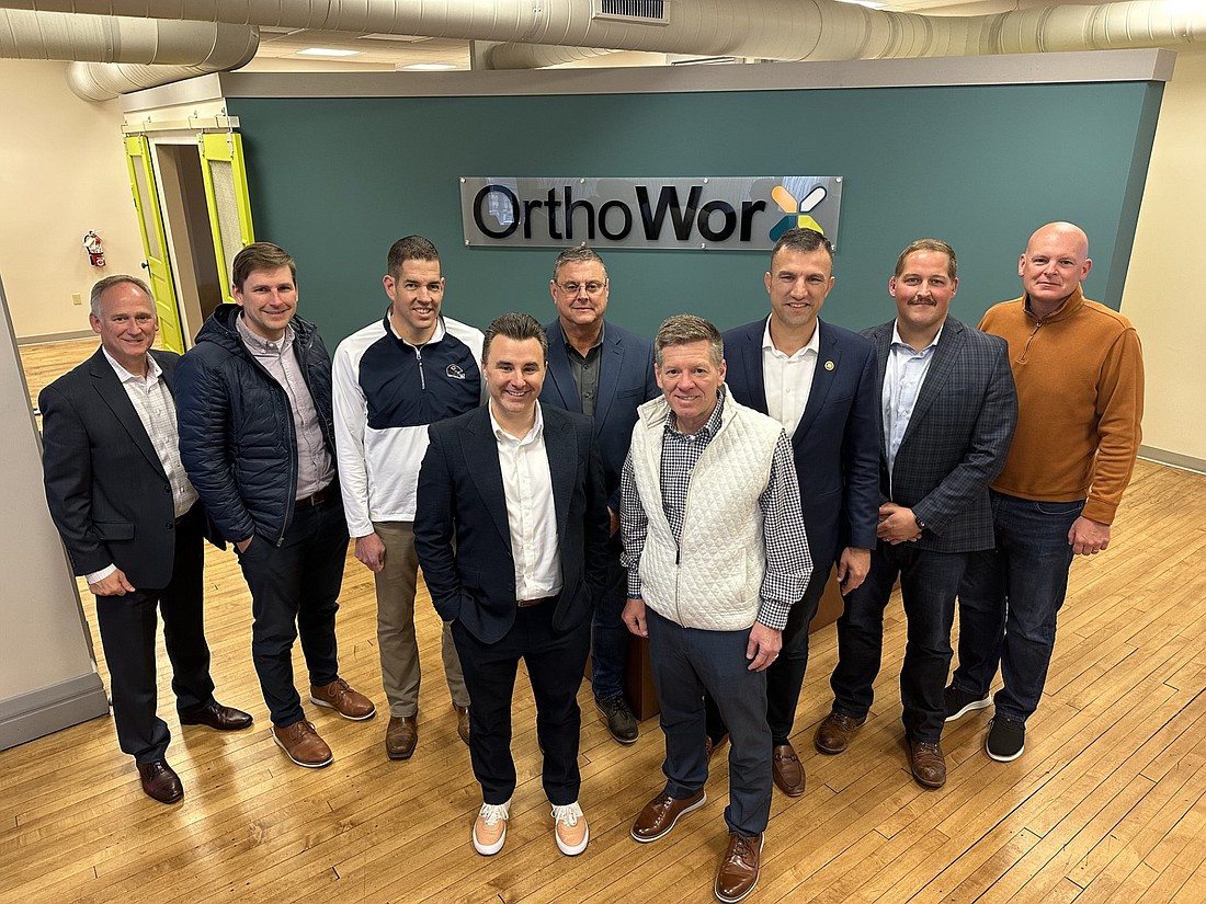 Participating in an orthopedic roundtable Thursday at OrthoWorx were (L to R), front row: Brandon Noll, Plug N Play Indiana; Bob Vitoux, OrthoWorx; back row: District 22 state Rep. Craig Snow; Sean Miller, Paragon Medical; Jim Miller, Tecomet; Todd Speicher, Instrumental Machine & Development; 2nd District U.S. Congressman Rudy Yakym; Ryan Thornburgh, Precision Medical; and Warsaw Mayor Jeff Grose. Not pictured are Leanne Turner, DePuy Synthes; RJ Hall, Zimmer Biomet; and Jeremy Skinner, Warsaw community and economic development director. Photo by David Slone, Times-Union