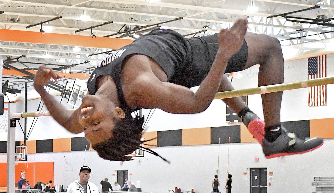 Warsaw sophomore Jordan Randall clears the bar with ease at 6'8" to win the high jump competition. Photo by Gary Nieter