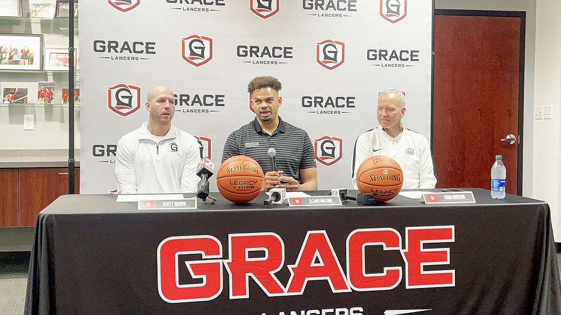 Grace men’s basketball head coach Scott Moore (left), center Elijah Malone (center) and Athletic Director Chad Briscoe (Right) sit at a press conference at the Manahan Orthopeadic Capital Center Monday morning. Malone announced he is going to use his final year of college eligibility to play for the University of Colorado this winter. Photo by Connor McCann