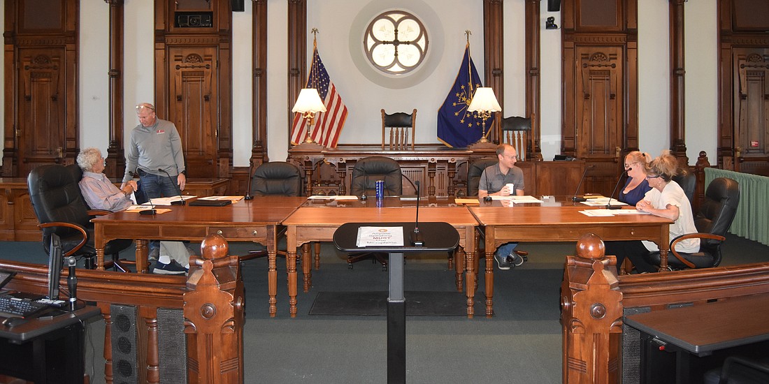 Members of the Kosciusko County Convention, Recreation & Visitors Commission socialize before the start of their meeting Wednesday. Pictured (L to R) are Treasurer John Hall, KCCRVC President Mark Skibowski (standing), Vice President Lyle Schrock, board member Jessica Hartman and board member Kathy Ray.  Photo by Patrick Webb, InkFreeNews