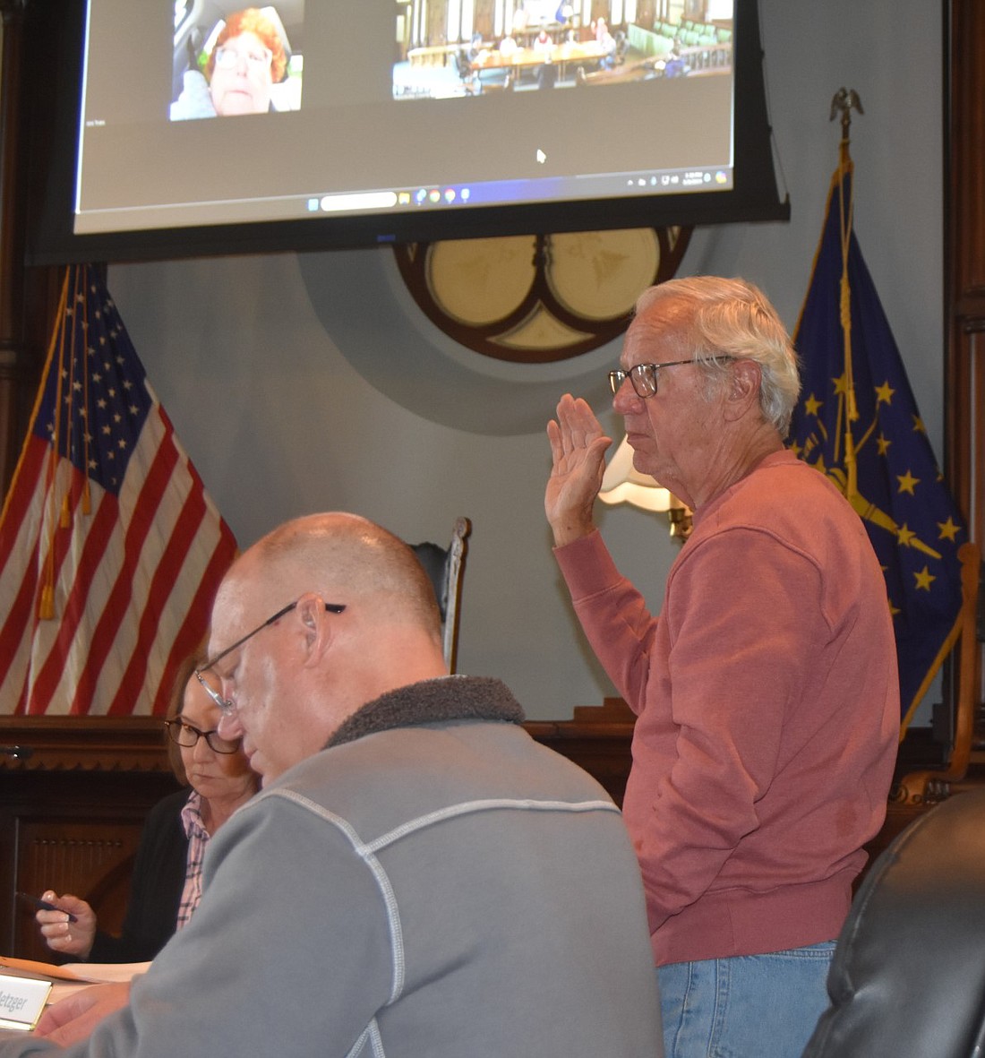 Kosciusko County Redevelopment Commission member Mike Metzger (standing) is sworn in at the Thursday meeting. To his right is Commission member Jan Orban and to his left is non-voting Commission member Brad Johnson. Photo by Patrick Webb, InkFreeNews