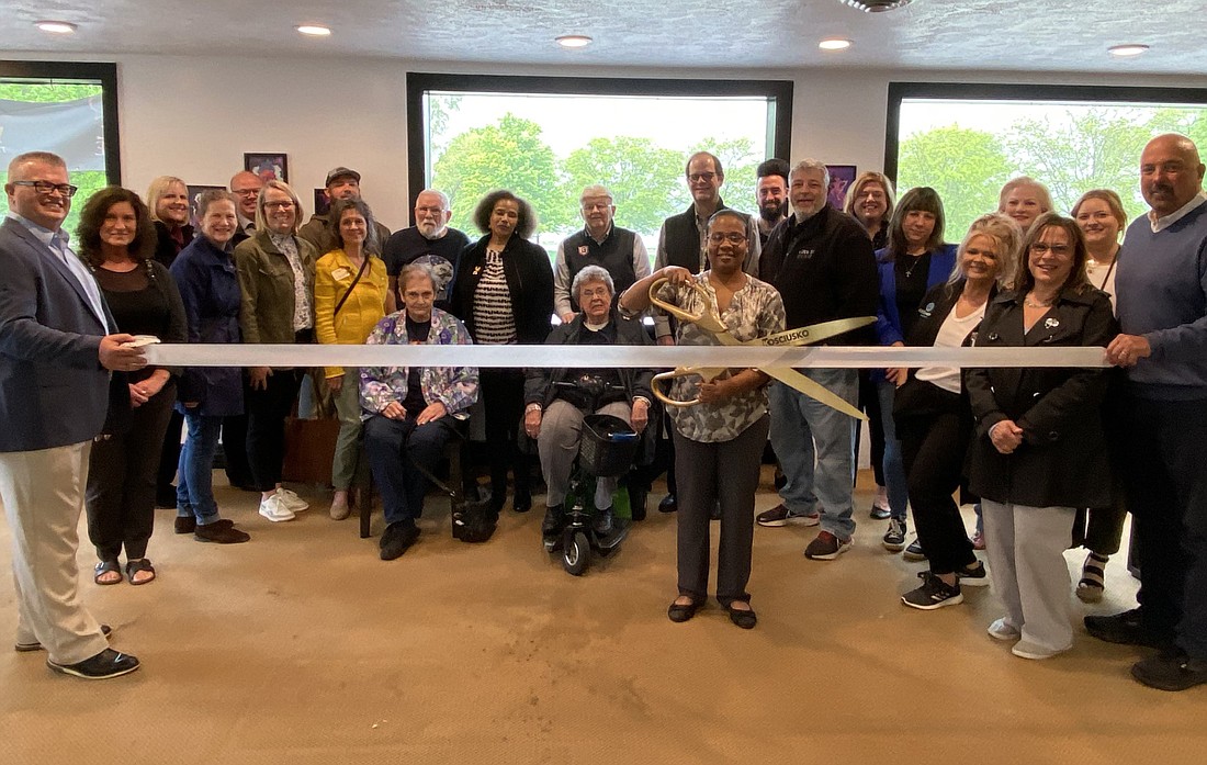 The Kosciusko Chamber of Commerce had a ribbon-cutting for Visions of Q Studio, owned by Quinisha Williams (center holding the scissors) on Thursday. The screen-printing business is on the upper level of 25 Kings Highway, Winona Lake. Photo by Leah Sander, InkFreeNews