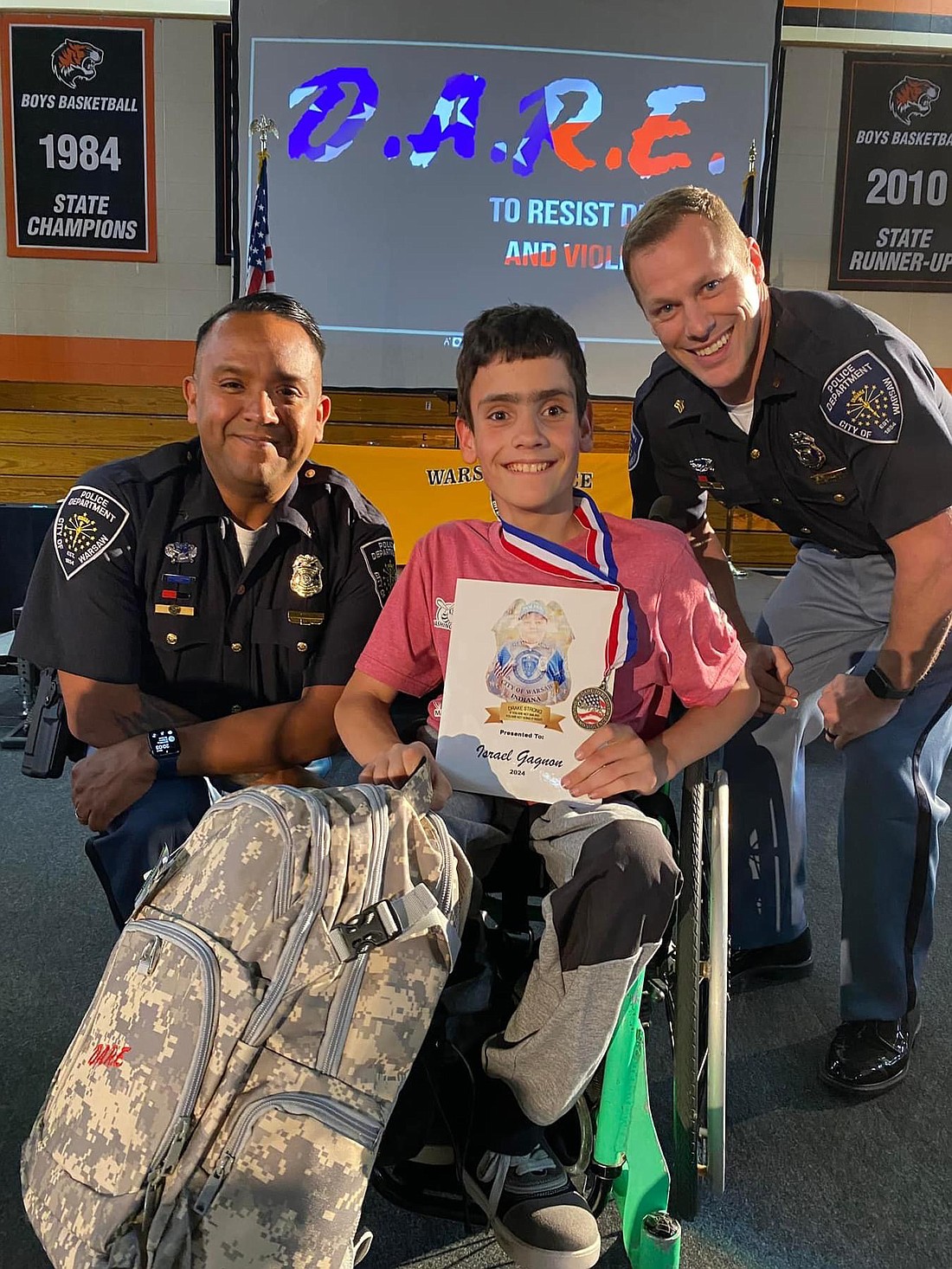 Pictured is Israel Gagnon (C) with officer Roy Navarro (L) and officer Lewis Fuller (R). Photo Provided.