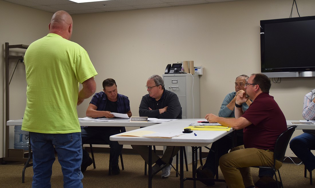 Thomas Michalski looks on while Kosciusko County Board of Zoning Appeals members John Beer and Kevin McSherry look over documents he provided. Area Plan Director Matt Sandy and BZA member Ron Robinson are on the right. Photo by Lauren Zeugner, InkFreeNews