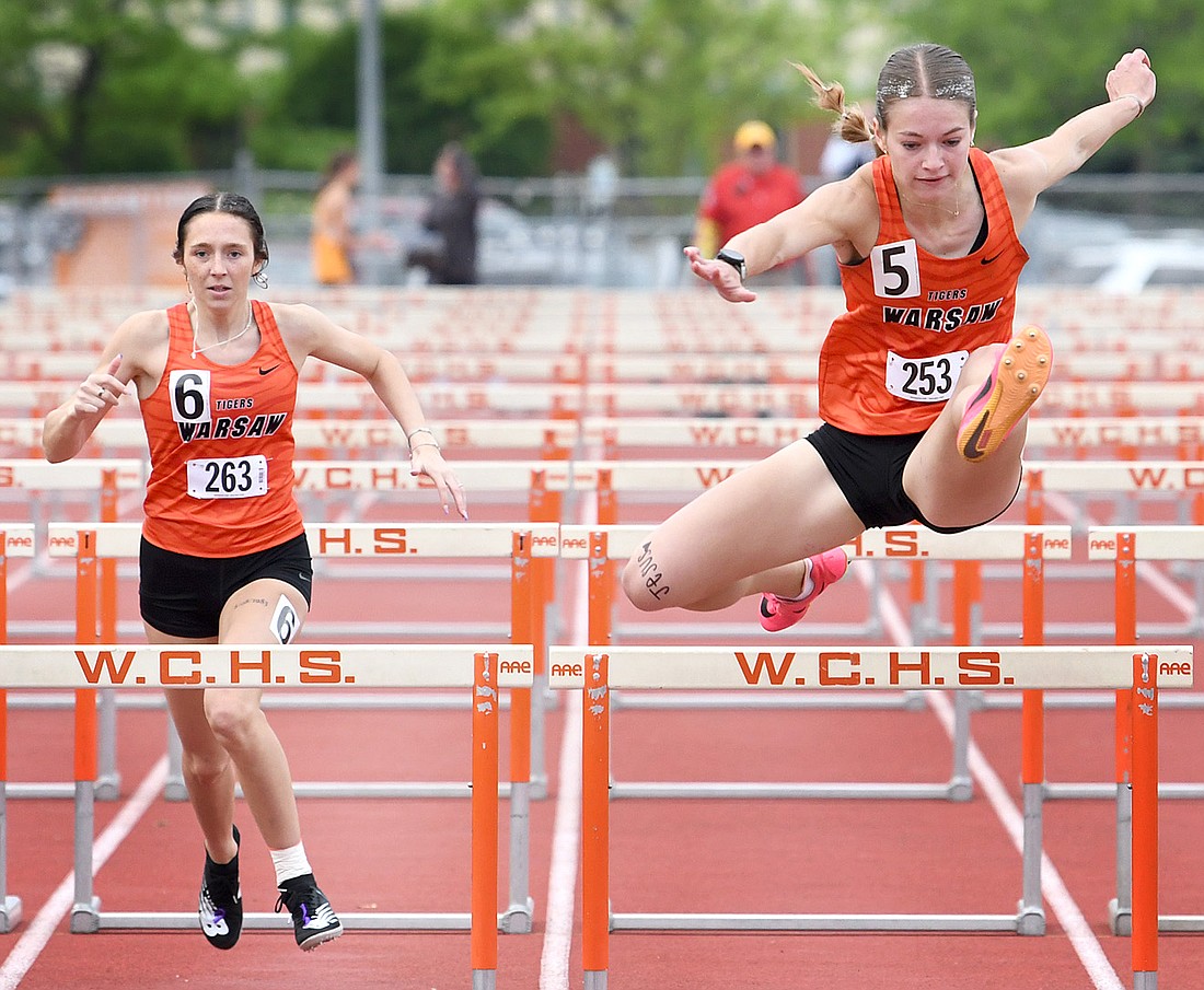 Warsaw junior classmates Rieanna Woods (L) and Annie Parker compete in the finals of the 100 meter high hurdles...Nieter