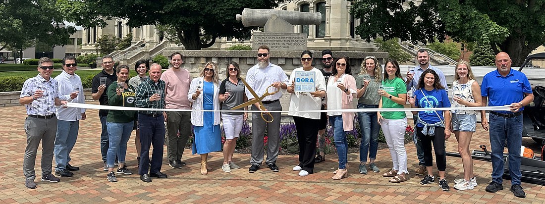 To kick off the Downtown Warsaw Designated Outdoor Refreshment Area (DORA), the Kosciusko Chamber of Commerce, Main Street Warsaw and the city of Warsaw had a ribbon-cutting ceremony Friday. Photo by David Slone, Times-Union