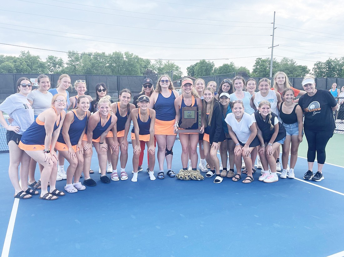 The Warsaw girls tennis team celebrates with its second trophy in a week after defeating Columbia City 5-0 in the sectional championship match Friday night at Warsaw. The Lady Tigers will take on Penn at NorthWood in Tuesday’s regional.