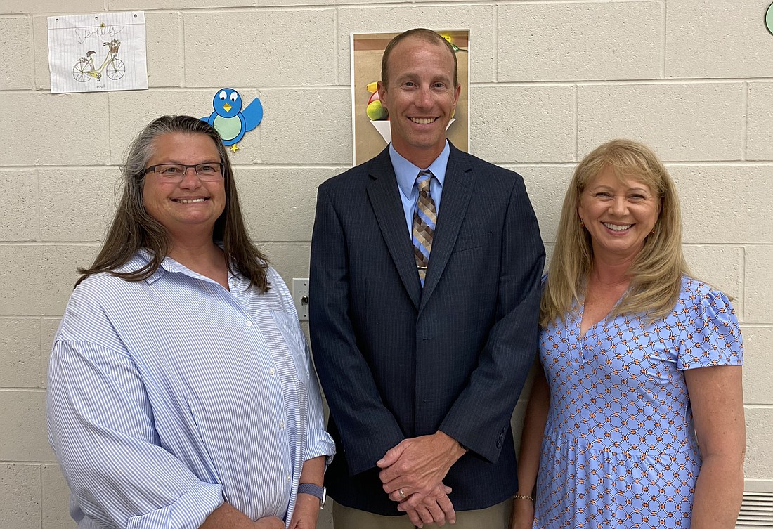 Retiring teachers June Yazel (L) and Jenny Higgins (R) were honored at the Tippecanoe Valley School Board meeting on Monday at Akron Elementary School. In the center is TVSC Board President Adam Heckaman. Photo by Leah Sander, InkFreeNews