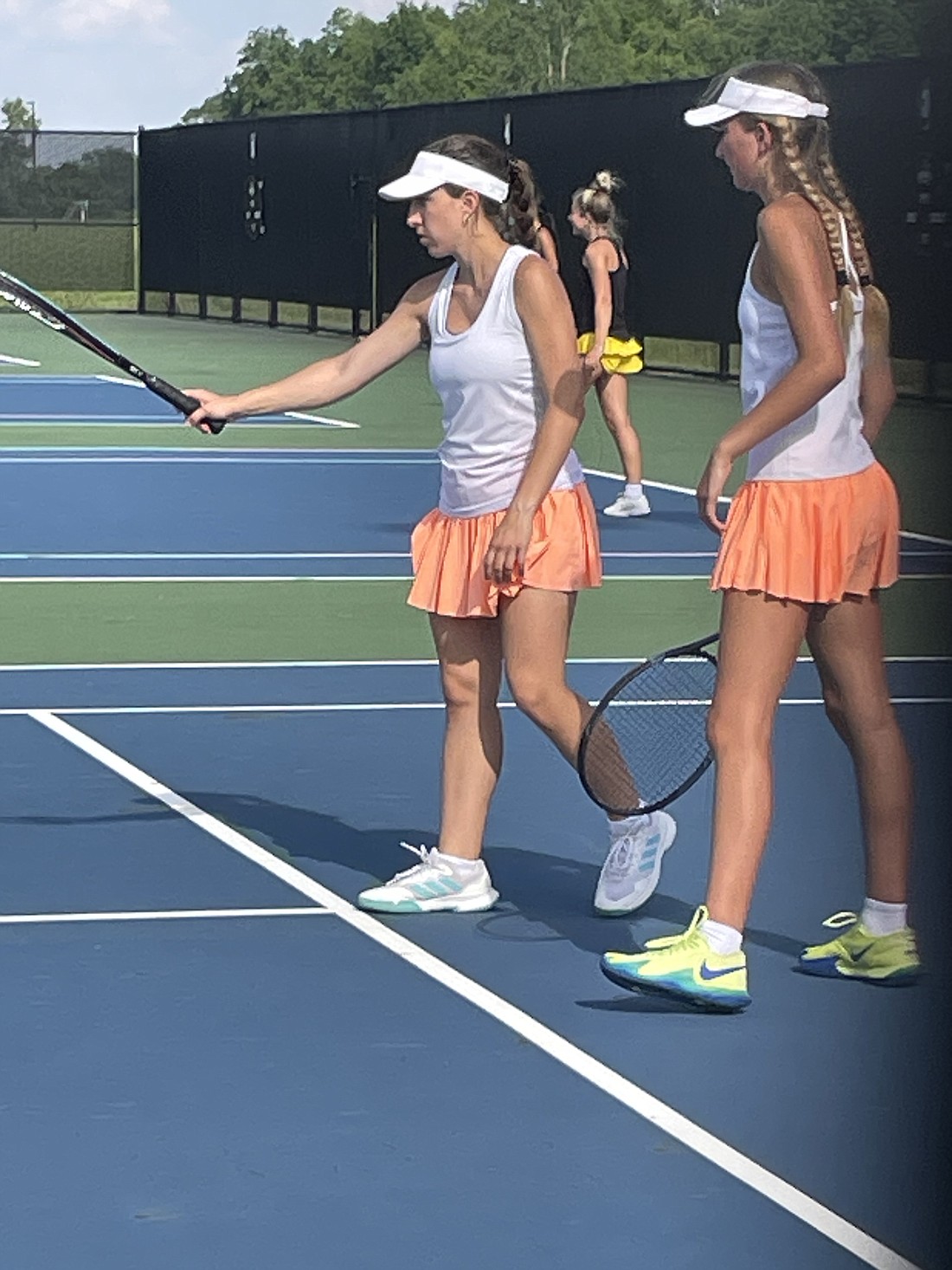 The Warsaw No. 2 doubles team of Lucy Ray (left) and Whitney Dawson (right) discuss strategy during their match against Penn in the IHSAA girls tennis regional Tuesday at NorthWood.