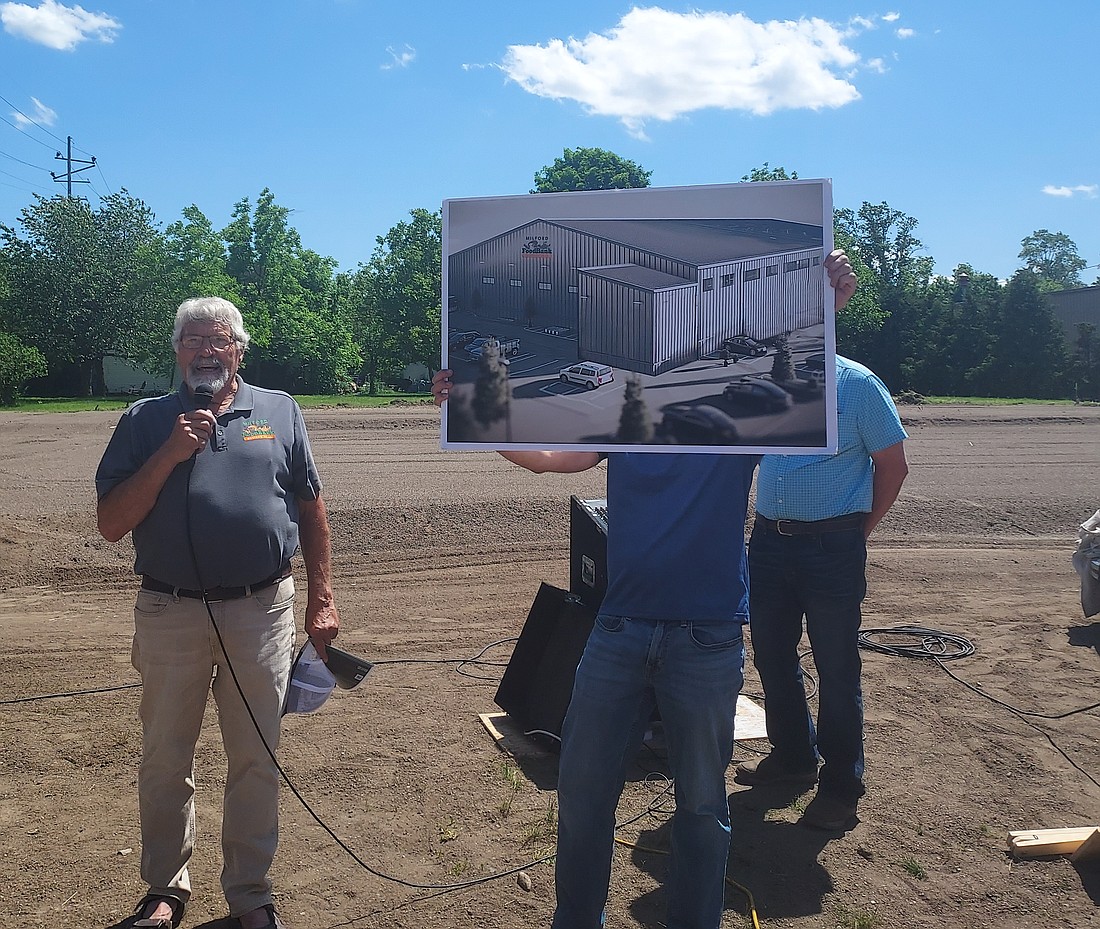 Milford Food Bank Board President Joe Shetler (L) speaks during the kicked off event for the fundraiser for its distribution center while Director Regg Beer holds a rendering of the distribution center. Photo by Jackie Gorski, TIMES-UNION