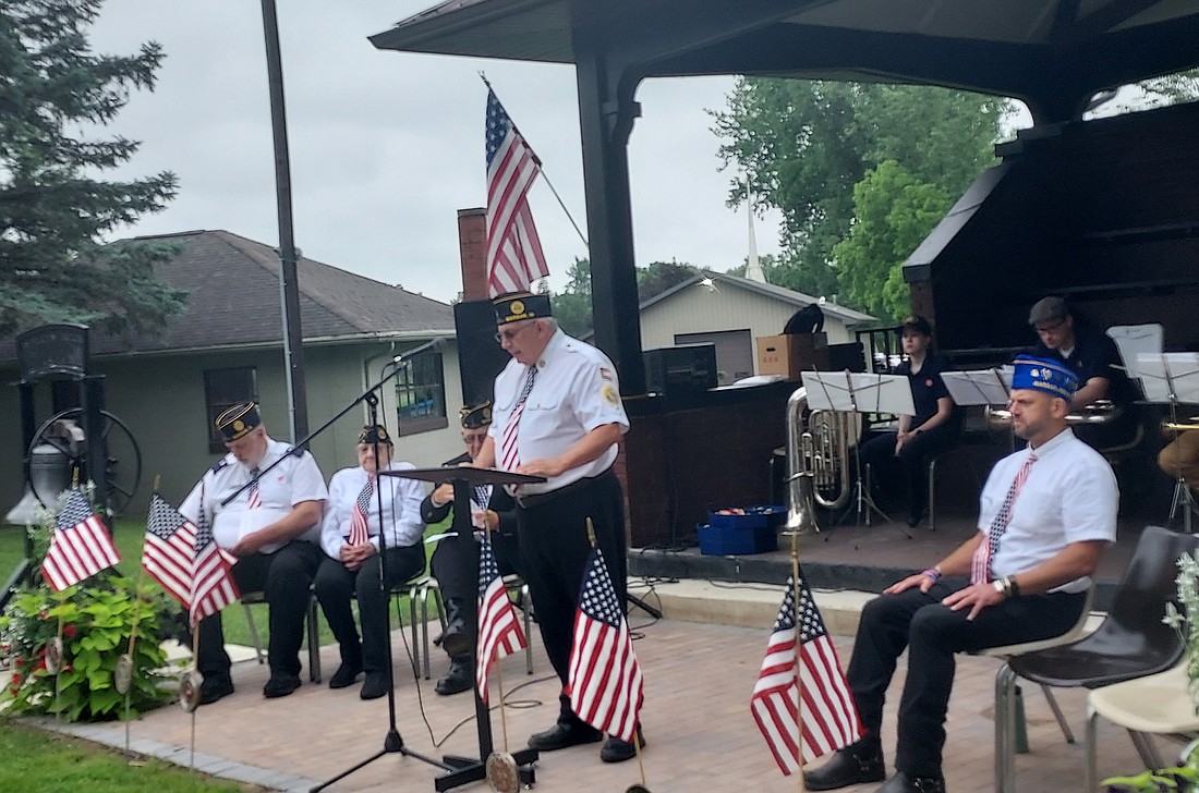 Larry Burkhart (C), retired U.S. Air Force member, American Legion second district manager and member of American Legion Post 49, speaks at the Memorial Day service at Oakwood Cemetery Monday. Photo by Jackie Gorski, Times-Union