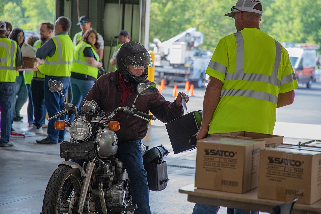 A Kosciusko REMC member casts his vote from his motorcycle at the 2023 Annual Drive-Through Meeting. Photo provided.