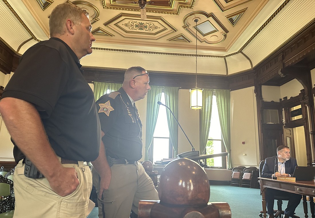 Kosciusko County Sheriff Jim Smith (R) and Lt. Mike Mulligan (L) talks to the Kosciusko County Commissioners Tuesday about Extra Duty Solutions. Photo by David Slone, Times-Union