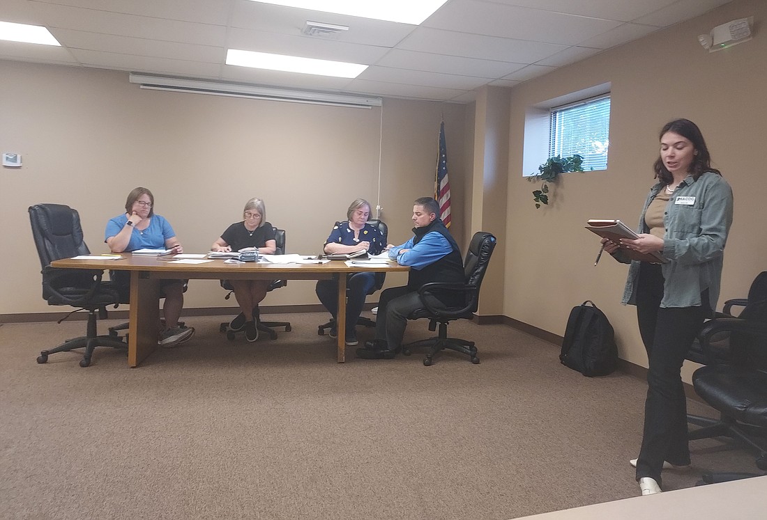 Olivia Nix, community development planner with Michiana Area Council of Governments (far right), speaks during a public hearing about the grant application for funding for the downtown master plan project. Listening to her (L to R) are Mentone Clerk-Treasurer Amanda Yaprak, Town Council members Jill Gross and Shelly Krueger and town attorney Andrew Grossnickle. Photo by Jackie Gorski, Times-Union