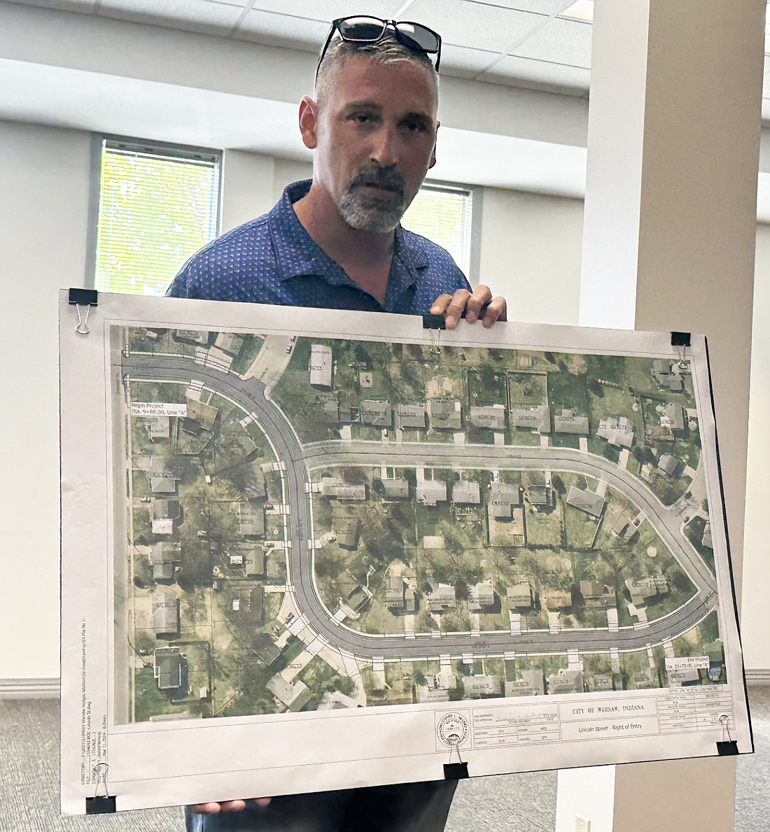 Warsaw Public Works Superintendent Dustin Dillon displays a blown-up graphic of what the reconstruction of Hodges Addition phase 3, Lincoln Street, project will look like once it’s completed, to the Board of Public Works and Safety on Friday. Photo by David Slone, Times-Union