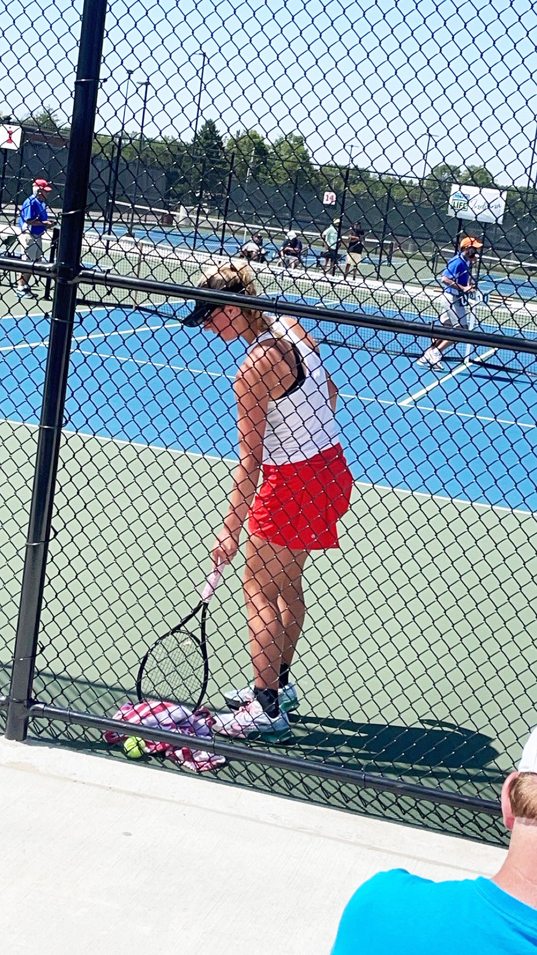 Warsaw junior tennis player Addie Lind takes a break in between points at the IHSAA individual tennis state finals Friday at North Central High School in Indianapolis.