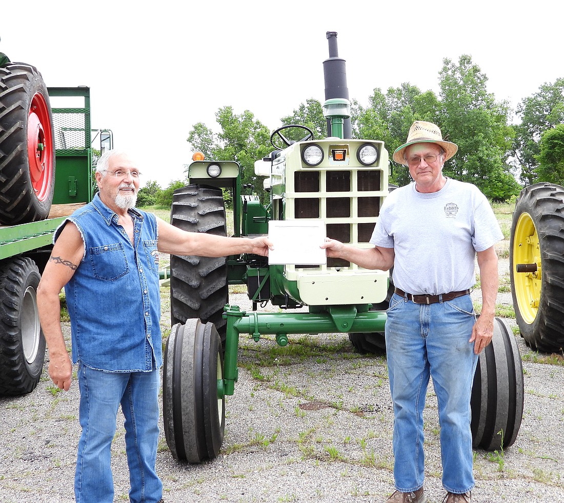 Pictured is James Peden with Rolf Holderman presenting best of show. Photo Provided.