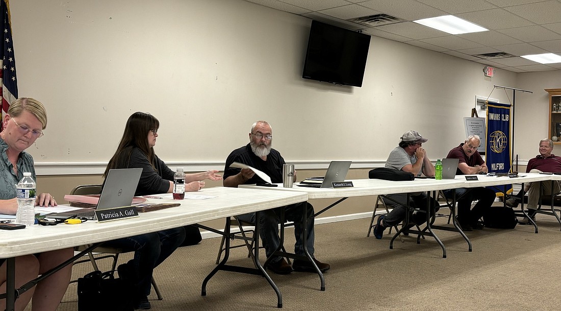 Milford Town Council members and officials look over paperwork during Monday’s meeting. Pictured (L to R) are Clerk-Treasurer Tricia Gall, Deputy Clerk Renda Loetz, Councilman Ken Long, Councilman Jim Smiley, Council President Doug Ruch and town attorney Jay Rigdon. Photo by Denise Fedorow