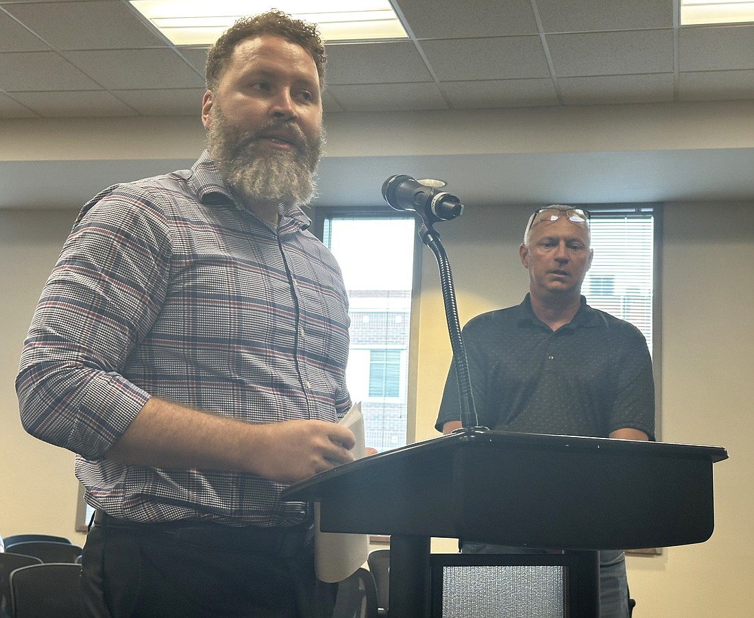 Warsaw City Planner Justin Taylor (L) talks to the Warsaw Common Council Monday night about moving the code enforcement inspector position from the Warsaw Building & Planning Department back to the Warsaw Police Department, as Human Resource Director Denny Harlan (R) listens. Photo by David Slone, Times-Union