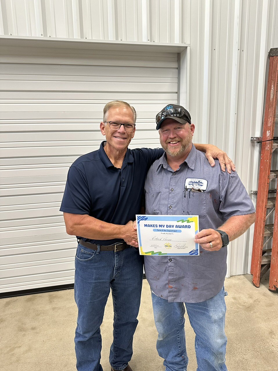 Warsaw Parks and Recreation Department employee Richard Pierson (R) won the "Makes My Day Award" for May. With him is Warsaw Parks and Recreation Department Superintendent Larry Plummer. Photo Provided