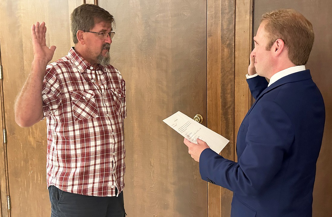 Chauncey Smith (L) is given the oath of office from Kosciusko County Republican Party Central Committee Secretary Austin Rovenstine (R) after Smith won the caucus to join the Pierceton Town Board Thursday. Photo by David Slone, Times-Union