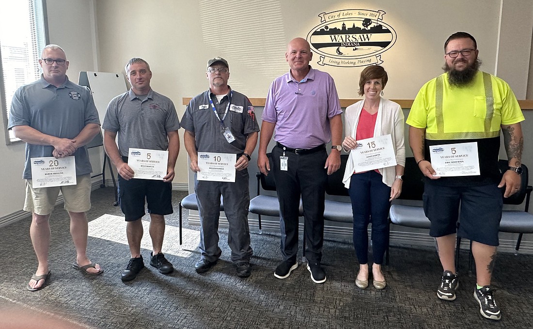 Six city employees were recognized Friday at the Warsaw Board of Public Works and Safety for their service anniversaries. Pictured (L to R) are Derek Shilling, Warsaw Wayne Fire Territory, 20 years; Kyle Martin, WWFT, five years; Roger Sarber, Warsaw Municipal Airport, 10 years; Warsaw Mayor Jeff Grose; Staci Young, mayor’s office, 15 years; and Eric Hoffhien, Warsaw Street Department, five years. Not pictured is Paul Heaton, Warsaw Police Department, 15 years. Photo by David Slone, Times-Union