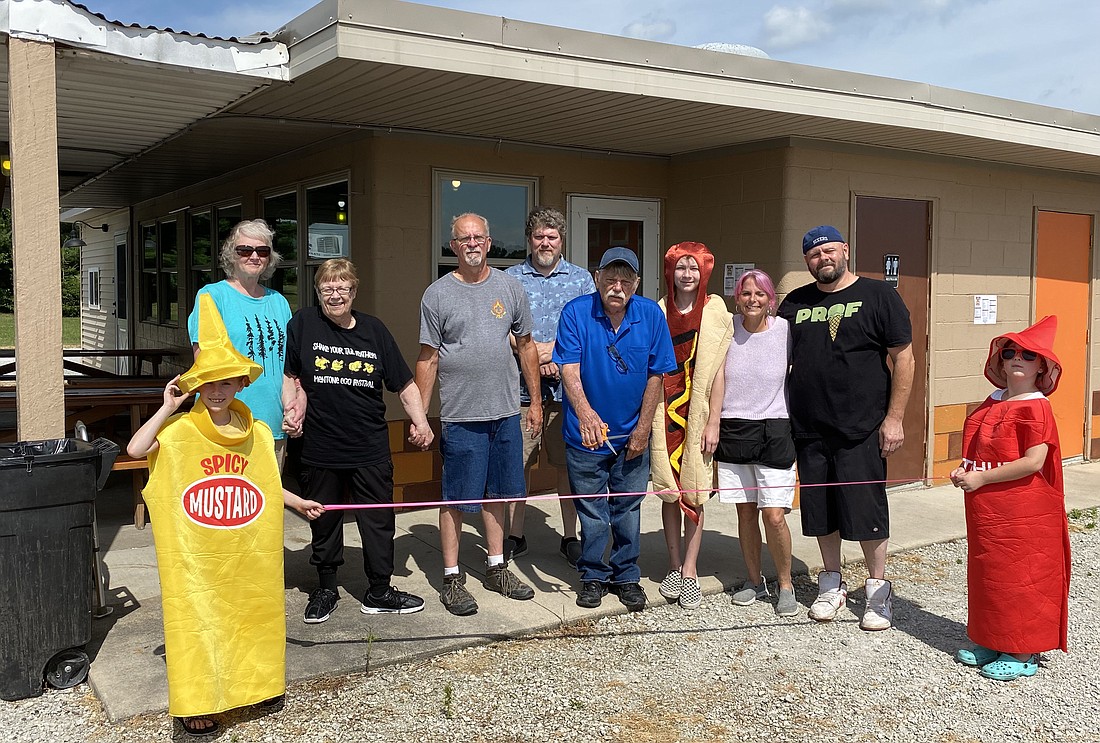 The Mentone Chamber of Commerce had a ribbon-cutting on Saturday to celebrate the new ownership at Mentone B&K. The restaurant is at 9396 W. Ind. 25 and is now owned by Leonard Goble and his son-in-law, Scott Powell, and daughter, Gretchen Powell. Pictured (L to R) are, front row: Makenna Powell and Ramona Powell; back row: Chamber member Krystal Lybarger, Chamber President Rita Price Simpson, Chamber Vice President Tim Croy, Chamber member Jeremy Lybarger, Goble, Asher Powell, Gretchen and Scott Powell. Photo by Leah Sander, InkFreeNews